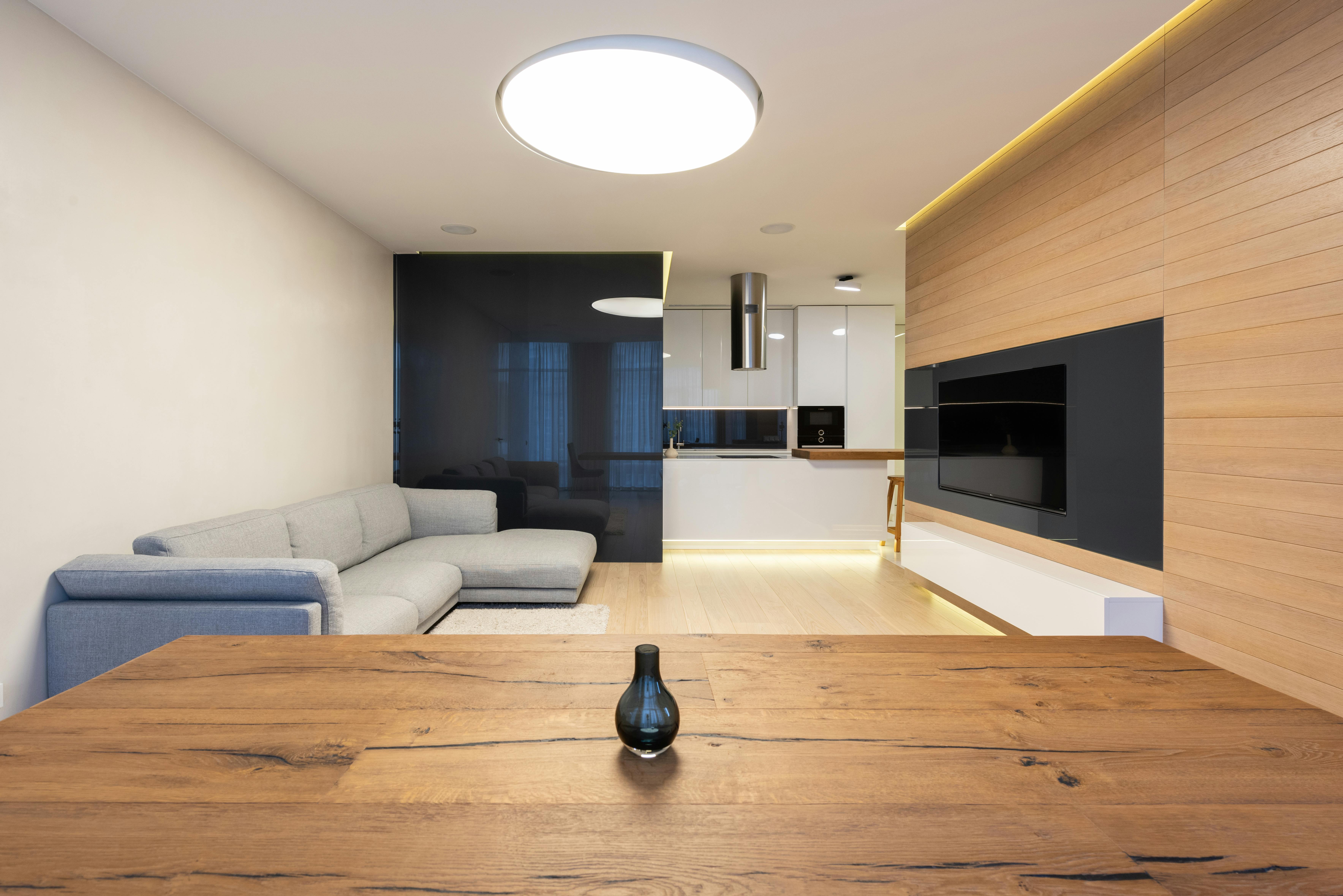 Spacious contemporary living room with open kitchen and sleek design.